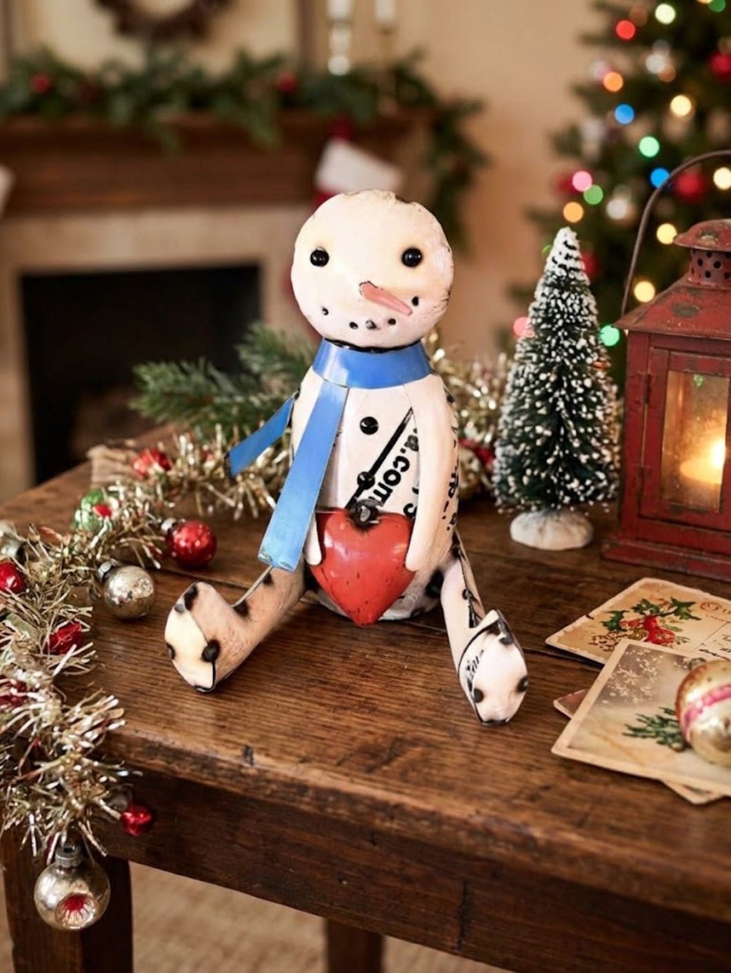 Primitive Christmas 8.75" Recycled Metal Sitting Snowman with Heart &amp; Scarf - The Primitive Pineapple Collection